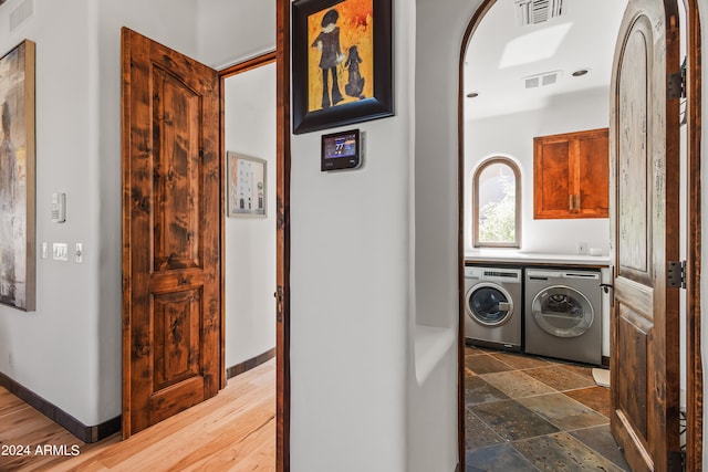 clothes washing area featuring independent washer and dryer and dark hardwood / wood-style flooring