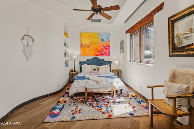 bedroom featuring hardwood / wood-style floors and ceiling fan