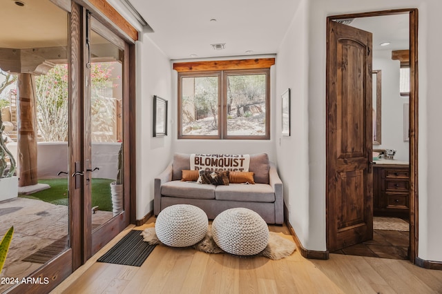 living area with french doors and light wood-type flooring