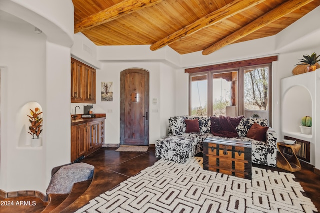 living room featuring beam ceiling, dark wood-type flooring, and wood ceiling