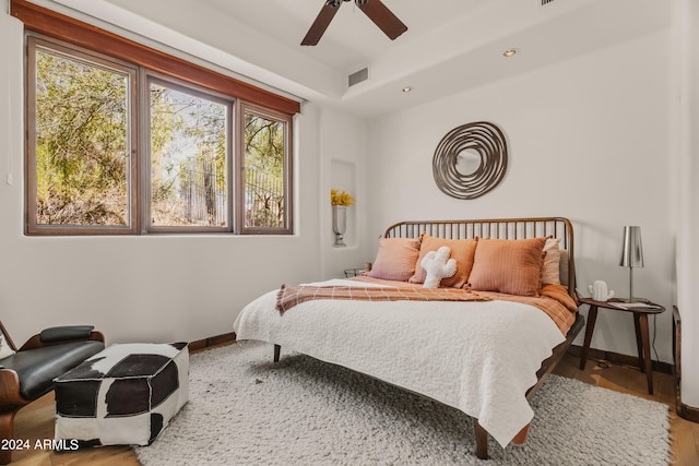 bedroom with ceiling fan and wood-type flooring