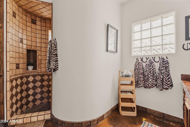 bathroom with vanity, concrete floors, and walk in shower