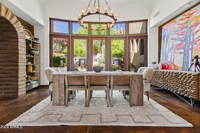 dining space with a high ceiling and a chandelier