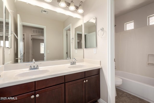 3449 E Sheffield Rd, Gilbert, AZ 85296 - full bathroom featuring toilet, double vanity, tile patterned flooring, and washtub / shower combination