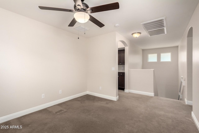 3449 E Sheffield Rd, Gilbert, AZ 85296 - carpeted spare room with arched walkways, a ceiling fan, and baseboards