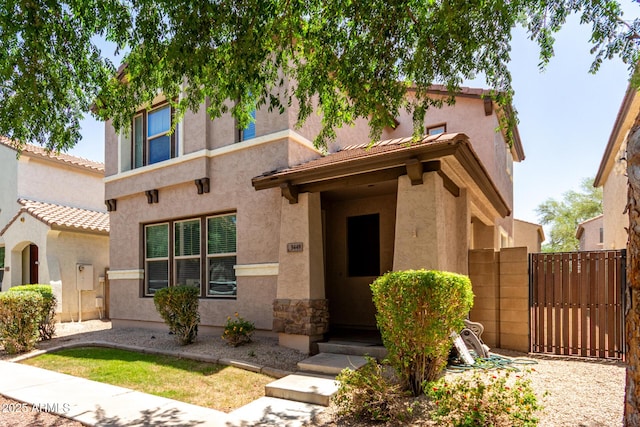 3449 E Sheffield Rd, Gilbert, AZ 85296 - view of front of property with stucco siding, a gate, a tiled roof, and fence