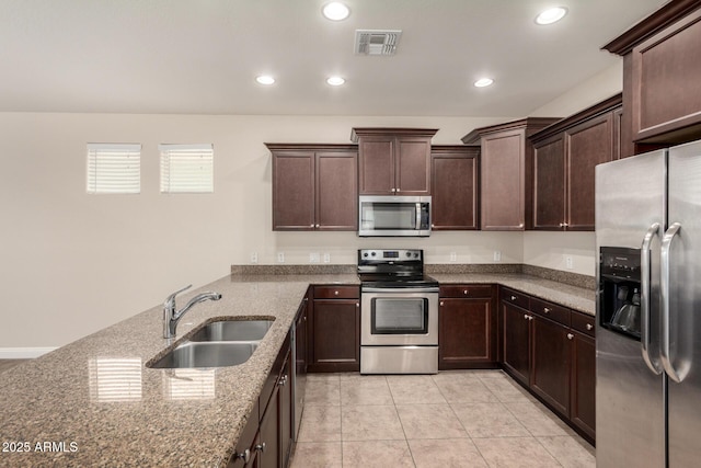 3449 E Sheffield Rd, Gilbert, AZ 85296 - kitchen featuring appliances with stainless steel finishes, a sink, stone countertops, dark brown cabinetry, and light tile patterned floors