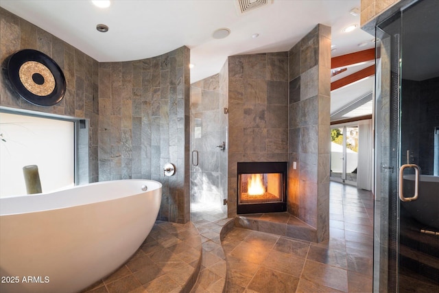 bathroom featuring tile walls, a fireplace, and separate shower and tub