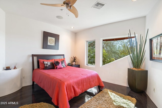 bedroom with ceiling fan and dark hardwood / wood-style flooring