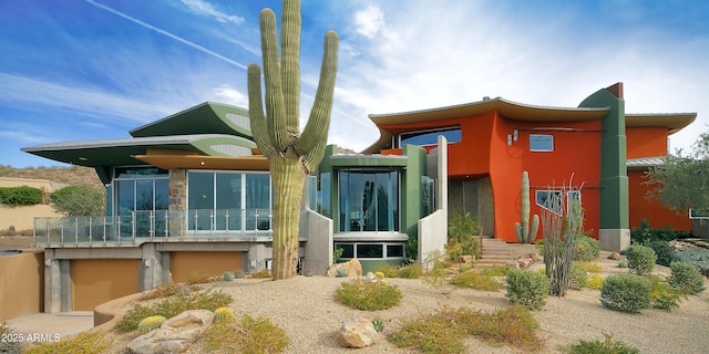 rear view of property featuring a garage