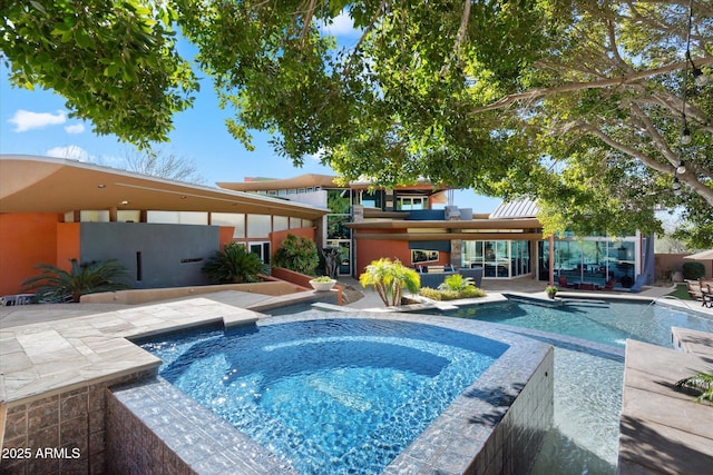 view of swimming pool featuring a patio and an in ground hot tub