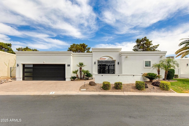 2737 E Arizona Biltmore Cir Unit 8, Phoenix, AZ 85016 - view of front of house featuring driveway, an attached garage, and stucco siding