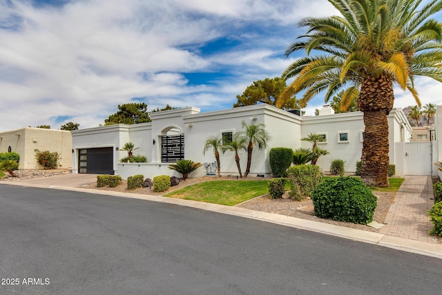 2737 E Arizona Biltmore Cir Unit 8, Phoenix, AZ 85016 - view of front of property featuring a garage, stucco siding, concrete driveway, and a gate