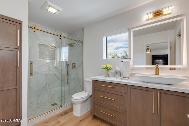 2737 E Arizona Biltmore Cir Unit 8, Phoenix, AZ 85016 - bathroom with a marble finish shower, vanity, wood finished floors, and toilet