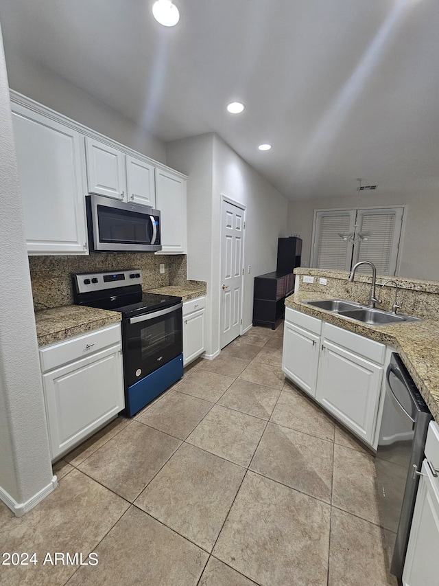 kitchen with white cabinetry, stainless steel appliances, sink, decorative backsplash, and light tile patterned flooring