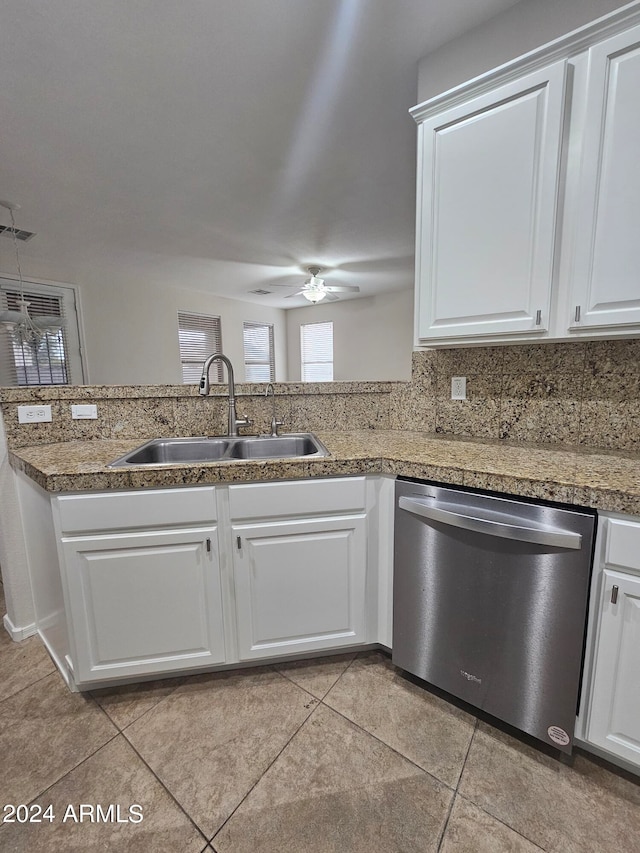 kitchen featuring white cabinetry, sink, ceiling fan, tasteful backsplash, and stainless steel dishwasher