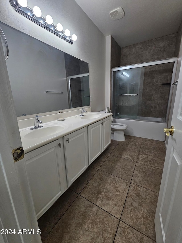 full bathroom featuring enclosed tub / shower combo, tile patterned floors, toilet, vanity, and a textured ceiling