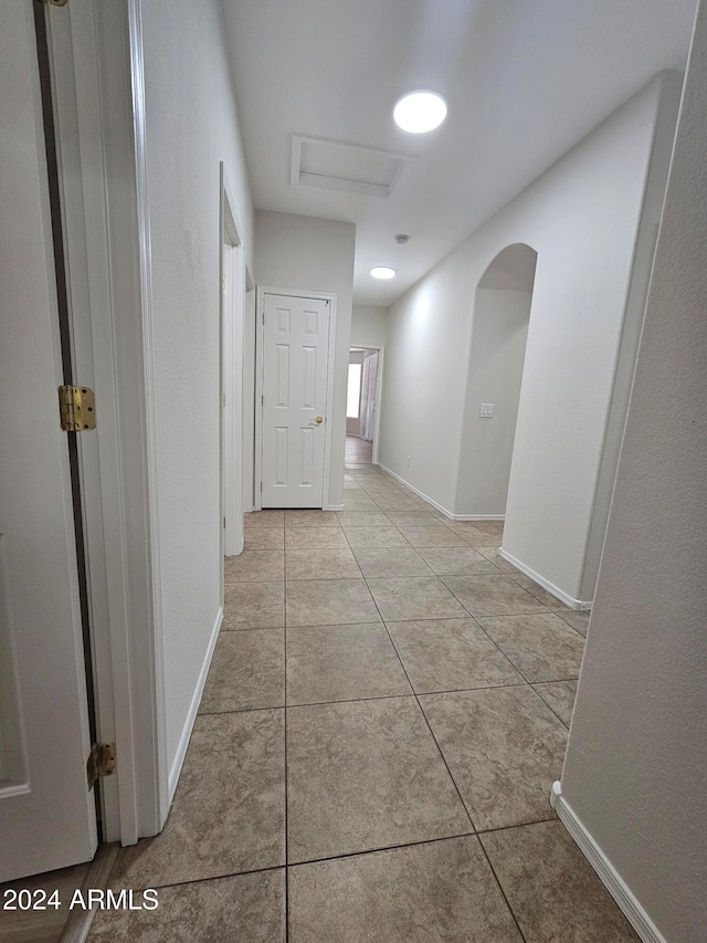 corridor with light tile patterned floors