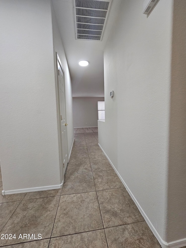 corridor featuring tile patterned flooring