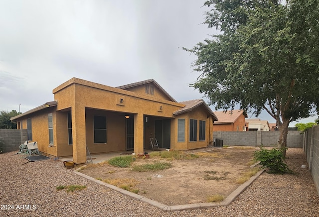 back of property featuring central AC