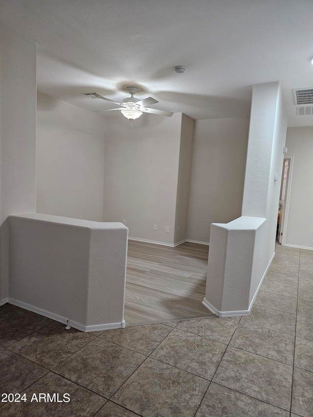 empty room with wood-type flooring and ceiling fan