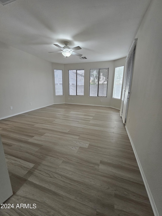 interior space with ceiling fan and hardwood / wood-style floors