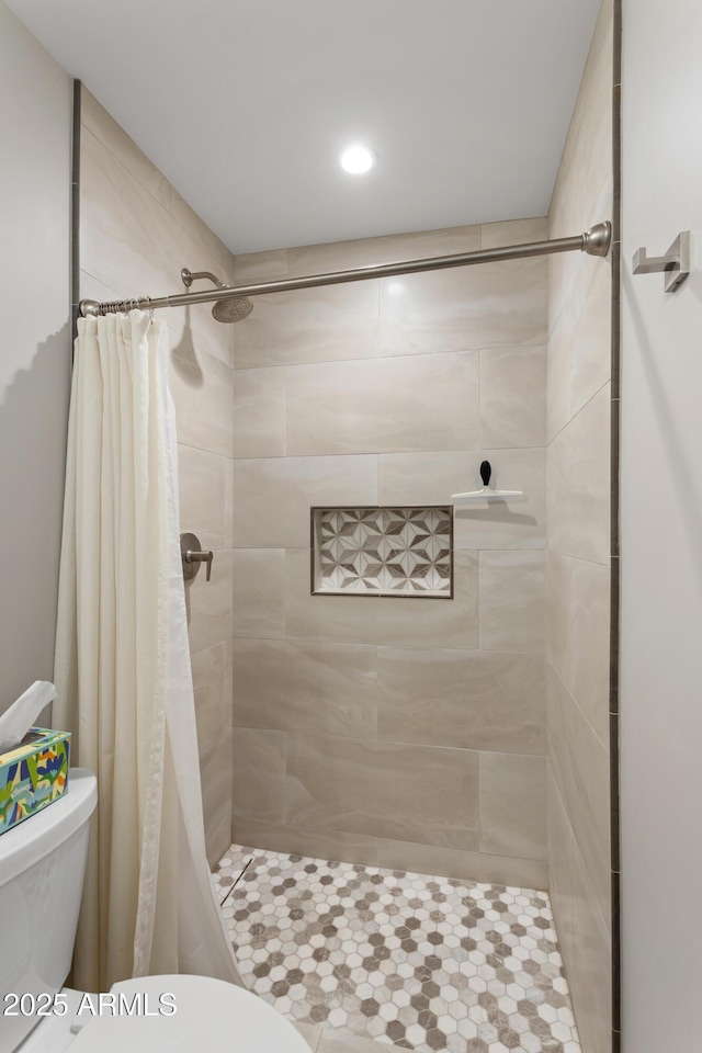 full bathroom featuring toilet, tile patterned flooring, a tile shower, and recessed lighting