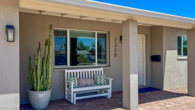 view of exterior entry with stucco siding