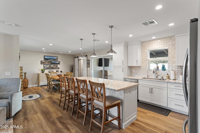 kitchen with a sink, recessed lighting, visible vents, and appliances with stainless steel finishes