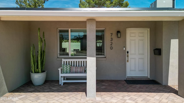 doorway to property with stucco siding
