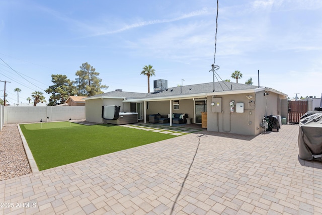 back of house featuring a fenced backyard, a patio area, and stucco siding