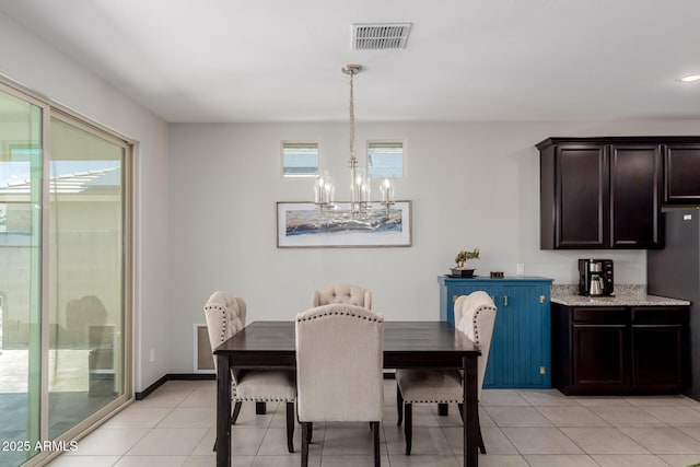 15276 W Latham St, Goodyear, AZ 85338 - dining space featuring a chandelier and light tile patterned floors