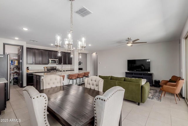 15276 W Latham St, Goodyear, AZ 85338 - dining room with light tile patterned floors, ceiling fan, recessed lighting, and a chandelier