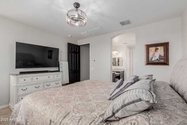 15276 W Latham St, Goodyear, AZ 85338 - bedroom with arched walkways, light carpet, and ensuite bath