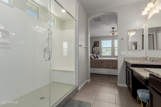 15276 W Latham St, Goodyear, AZ 85338 - bathroom featuring ensuite bathroom, a stall shower, tile patterned floors, and vanity