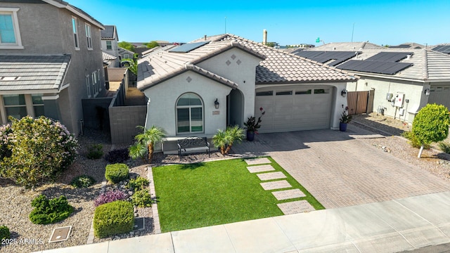 15276 W Latham St, Goodyear, AZ 85338 - view of front facade featuring a tiled roof, an attached garage, stucco siding, decorative driveway, and a residential view