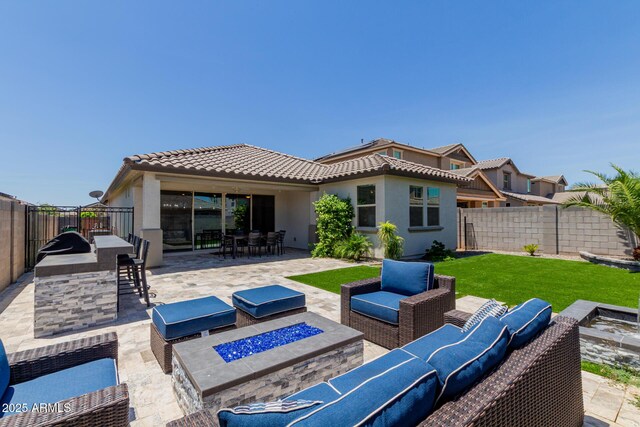 15276 W Latham St, Goodyear, AZ 85338 - rear view of house featuring an outdoor living space with a fire pit, a tiled roof, a patio, and a fenced backyard