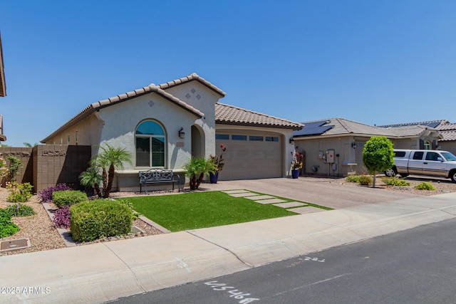 15276 W Latham St, Goodyear, AZ 85338 - mediterranean / spanish-style home featuring a tile roof, an attached garage, stucco siding, and concrete driveway