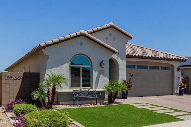 15276 W Latham St, Goodyear, AZ 85338 - mediterranean / spanish house with an attached garage, a tiled roof, driveway, and stucco siding