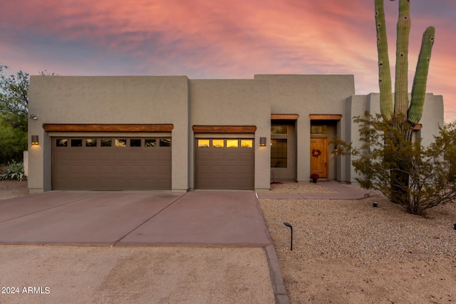 pueblo revival-style home with a garage