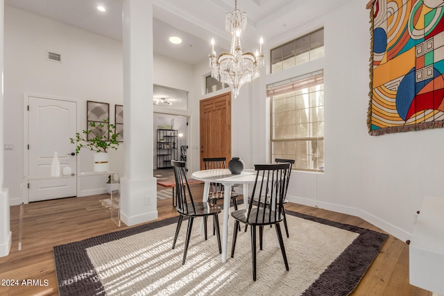 dining room with hardwood / wood-style flooring and a notable chandelier