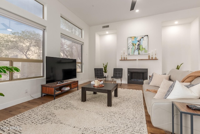 living room featuring ceiling fan and hardwood / wood-style floors