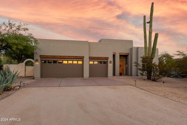 pueblo-style home featuring a garage