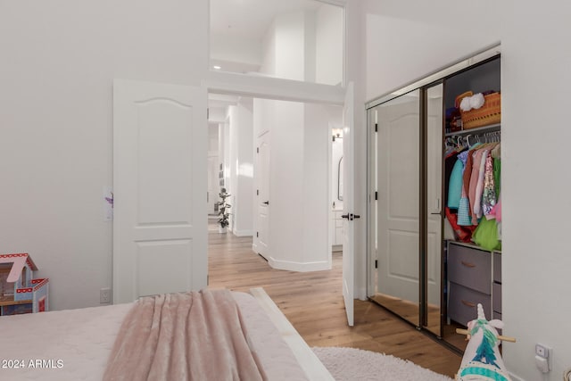 bedroom with a closet and light hardwood / wood-style flooring