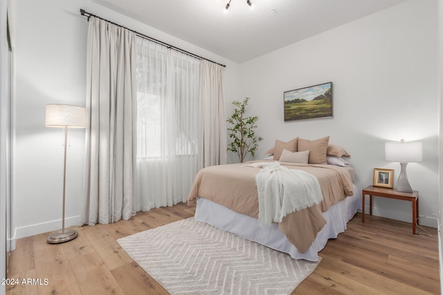 bedroom with light hardwood / wood-style floors