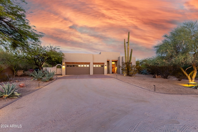 pueblo-style home with a garage