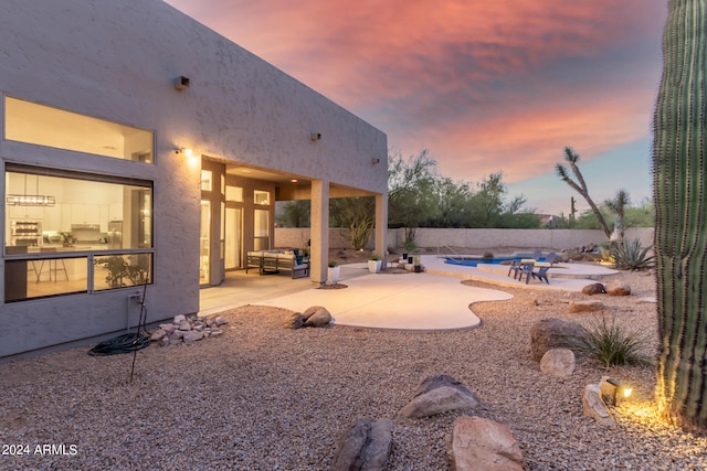 yard at dusk featuring a patio area