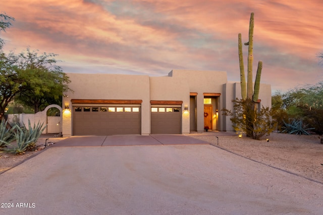 pueblo-style house featuring a garage