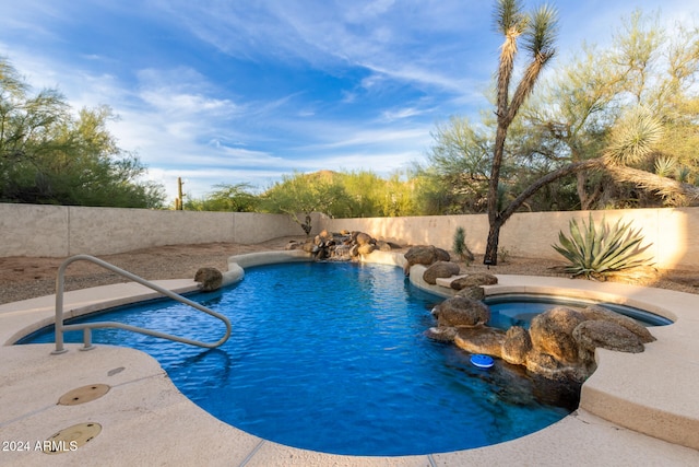 view of swimming pool with pool water feature