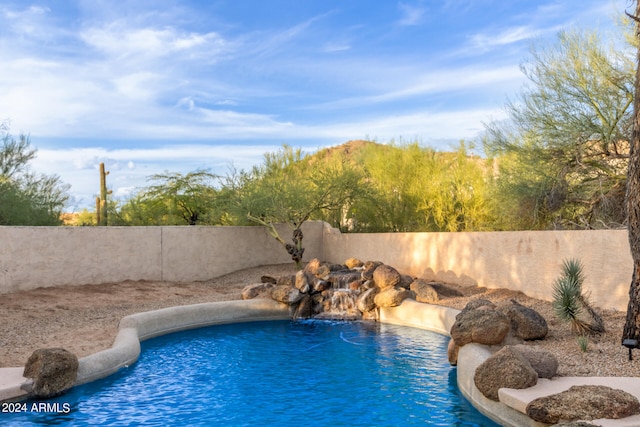 view of swimming pool featuring pool water feature